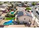 Aerial view of the backyard featuring a pool, patio, solar paneling, and mature landscaping at 17258 W Meghan Dr, Goodyear, AZ 85338