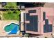 Overhead aerial shot of the backyard pool with solar panels on the roof and artificial grass at 17258 W Meghan Dr, Goodyear, AZ 85338