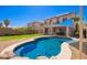 Backyard features include a sparkling pool, covered patio, and low-maintenance landscaping at 17258 W Meghan Dr, Goodyear, AZ 85338