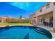 Lush backyard boasts a sparkling pool, covered patio, and ample space for entertaining at 17258 W Meghan Dr, Goodyear, AZ 85338