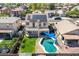 Aerial view of the backyard with a pool, patio, lawn and solar panels on the roof of the two-story home at 17258 W Meghan Dr, Goodyear, AZ 85338