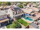 Aerial view of a backyard with a pool, patio, lawn and solar panels on the roof of the two-story home at 17258 W Meghan Dr, Goodyear, AZ 85338