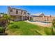 Expansive backyard with a pool, patio, lush lawn, and ample space for outdoor enjoyment at 17258 W Meghan Dr, Goodyear, AZ 85338