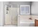 Bright bathroom with glass-enclosed shower and tub at 17258 W Meghan Dr, Goodyear, AZ 85338