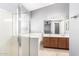 Bathroom featuring a glass shower enclosure, soaking tub, and double vanity at 17258 W Meghan Dr, Goodyear, AZ 85338