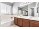 Bright bathroom offers a soaking tub, double sink vanity, and plantation shutters at 17258 W Meghan Dr, Goodyear, AZ 85338