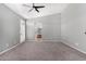Large bedroom with carpet, an ensuite bathroom, and a ceiling fan, bathed in natural light at 17258 W Meghan Dr, Goodyear, AZ 85338