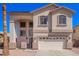 Charming two-story home with a two-car garage, neutral facade, and an inviting front entrance and desert landscape at 17258 W Meghan Dr, Goodyear, AZ 85338