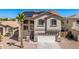 Two-story home featuring a two-car garage, a manicured lawn and mature landscaping at 17258 W Meghan Dr, Goodyear, AZ 85338