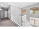 Bright upstairs hallway with carpet, complemented by natural light and a view through the windows at 17258 W Meghan Dr, Goodyear, AZ 85338