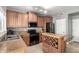 Updated kitchen features stainless steel appliances, wood cabinets and an island with a wine rack at 17258 W Meghan Dr, Goodyear, AZ 85338
