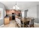 Cozy kitchen and dining area featuring wood cabinets, stainless steel appliances, and ample counter space at 17258 W Meghan Dr, Goodyear, AZ 85338