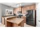 Modern kitchen with stainless steel refrigerator and island with countertop seating at 17258 W Meghan Dr, Goodyear, AZ 85338