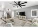 Comfortable living room featuring a large sectional sofa, TV and access to the upper level at 17258 W Meghan Dr, Goodyear, AZ 85338