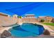 A sparkling pool with rock waterfall feature provides a tranquil outdoor oasis at 17258 W Meghan Dr, Goodyear, AZ 85338