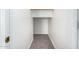 A functional walk-in closet with neutral carpet and white walls, offering ample storage space at 17258 W Meghan Dr, Goodyear, AZ 85338