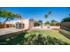 Green backyard featuring grass, block wall, a storage shed, and basketball hoop at 1739 E Knox Rd, Tempe, AZ 85284