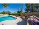 Stunning pool area with manicured landscaping, mature trees, and an outdoor grill for entertaining at 1739 E Knox Rd, Tempe, AZ 85284