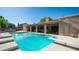 Sparkling pool with diving board surrounded by lush landscaping, patio, and outdoor kitchen area at 1739 E Knox Rd, Tempe, AZ 85284
