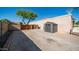 Spacious backyard featuring a shed, basketball hoop, and a mature shade tree for outdoor activities at 1739 E Knox Rd, Tempe, AZ 85284