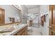 Bright bathroom featuring a vanity with a white sink, a tiled countertop, and a glass-enclosed shower-tub combination at 1739 E Knox Rd, Tempe, AZ 85284