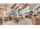 Spacious primary bedroom boasting a vaulted ceiling with beams and neutral carpeted floors at 1739 E Knox Rd, Tempe, AZ 85284