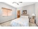 Cozy bedroom features neutral walls, carpet, a ceiling fan, and a window with wood-style blinds at 1739 E Knox Rd, Tempe, AZ 85284