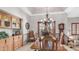 Traditional dining room features chandelier lighting, wooden table, and built-in wooden cabinets at 1739 E Knox Rd, Tempe, AZ 85284