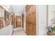 Long hallway with tiled floors, wood cabinets, and multiple framed pictures on the wall at 1739 E Knox Rd, Tempe, AZ 85284