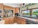 Kitchen with granite countertops and dark appliances and a view of the beautiful backyard pool at 1739 E Knox Rd, Tempe, AZ 85284