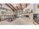 Spacious living room boasts a fireplace, wooden ceiling beams, and French doors to the pool area at 1739 E Knox Rd, Tempe, AZ 85284