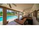 Covered outdoor kitchen featuring a brick countertop, a built-in grill, and views of the inviting pool area at 1739 E Knox Rd, Tempe, AZ 85284