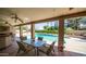 Covered patio features comfortable seating, ceiling fans, and a picturesque view of the pool and backyard at 1739 E Knox Rd, Tempe, AZ 85284