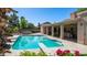 Sparkling pool with diving board, lush landscaping, and covered outdoor seating area with bbq and bar at 1739 E Knox Rd, Tempe, AZ 85284