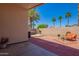 Inviting back patio featuring a hot tub, seating area, and well-manicured landscaping at 174 W Del Rio St, Gilbert, AZ 85233