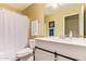 Bright bathroom featuring a white vanity, framed mirror, and a shower with curtain at 174 W Del Rio St, Gilbert, AZ 85233