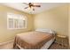 Neutral guest bedroom with shuttered window, ceiling fan and carpeted floor at 174 W Del Rio St, Gilbert, AZ 85233