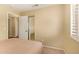Bedroom featuring shuttered window and a view of the interior hall and closet at 174 W Del Rio St, Gilbert, AZ 85233