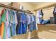 Walk-in closet with hanging clothes and shelving for storage at 174 W Del Rio St, Gilbert, AZ 85233