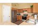 Functional kitchen with stainless steel appliances, wood cabinets, and tile flooring at 174 W Del Rio St, Gilbert, AZ 85233