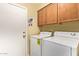 Functional laundry room with washer, dryer, and ample cabinet space at 174 W Del Rio St, Gilbert, AZ 85233