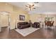 Spacious living room featuring wood-look floors, a ceiling fan, and neutral paint at 174 W Del Rio St, Gilbert, AZ 85233