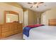 Spacious main bedroom features a ceiling fan, dresser, and soft neutral carpet at 174 W Del Rio St, Gilbert, AZ 85233