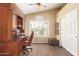 Bright home office features a hutch desk, shuttered window, and tile flooring at 174 W Del Rio St, Gilbert, AZ 85233