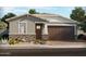 Charming single-story home with stone accents, landscaped yard, and attached two-car garage at 17570 W Adams St, Goodyear, AZ 85338