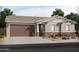 Charming one-story home with a two-car garage, stone accents, and a beautifully landscaped front yard at 17703 W Ford St, Goodyear, AZ 85338