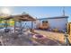 Spacious backyard with a covered patio, a fire pit, lush green plants, and room for outdoor entertaining at 17913 E Watford Dr, Queen Creek, AZ 85142