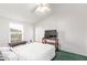 Bright bedroom featuring a comfortable bed, wooden bedside table, and a window providing natural light at 17913 E Watford Dr, Queen Creek, AZ 85142
