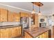 Modern kitchen featuring wood cabinets, stainless steel appliances, and a tiled center island at 17913 E Watford Dr, Queen Creek, AZ 85142