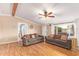 Spacious living room featuring wood floors, comfortable seating, and ample natural light at 17913 E Watford Dr, Queen Creek, AZ 85142
